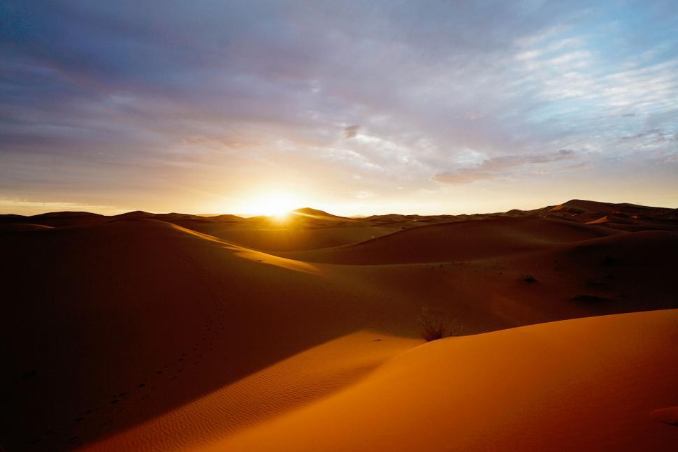 Free Image of Sun Setting Over Desert Landscape 