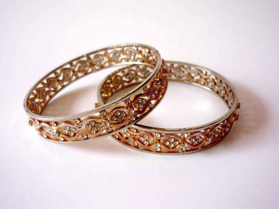 Free Image of Two Rings Resting on White Table 