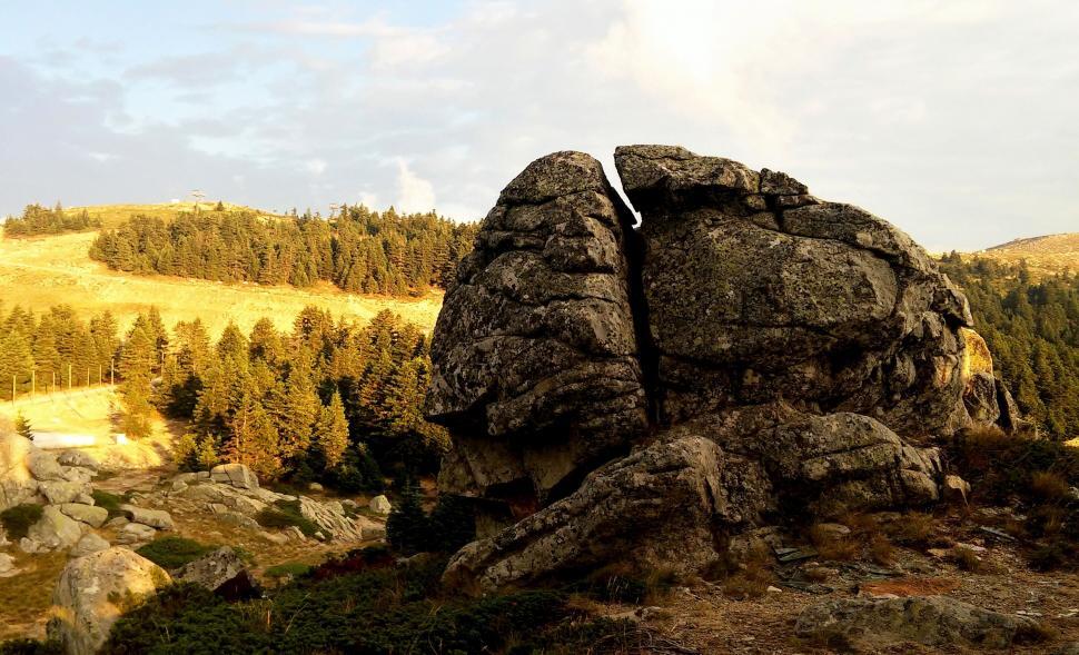 Free Image of Giant boulder in a mountainous landscape at sunset 