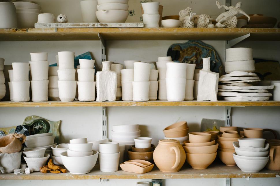 Free Image of Pottery collection on shelves in a workshop 