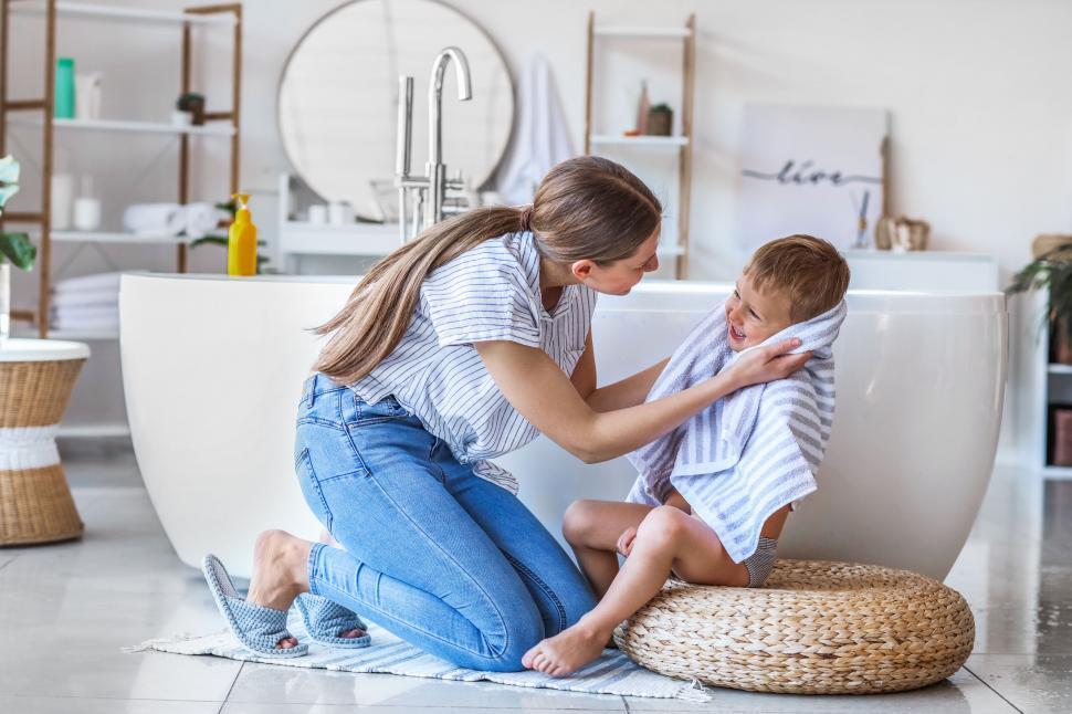 Free Image of Mother comforting child in a modern bathroom 