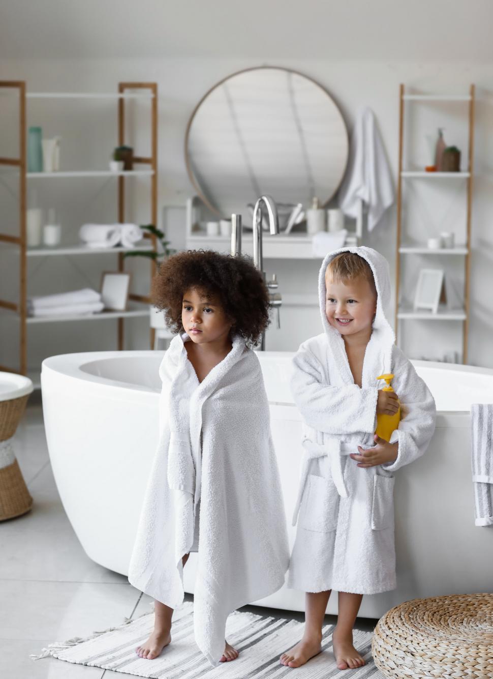 Free Image of Two children in bathrobes in bathroom 