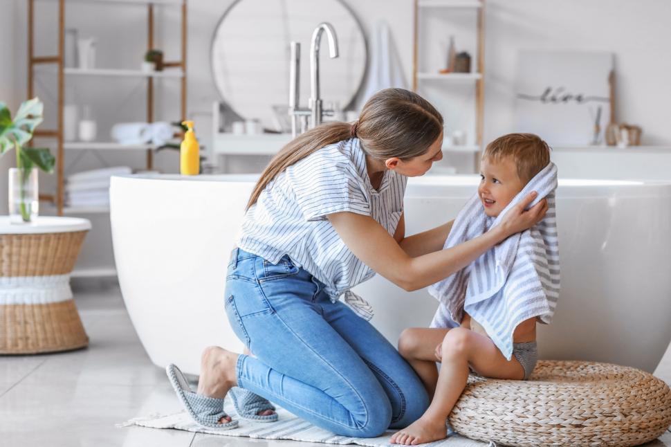 Free Image of Mother drying son s hair after bath 