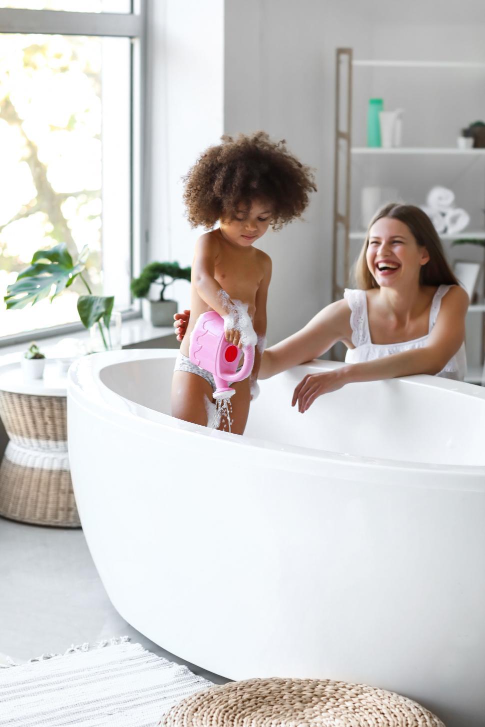 Free Image of Playful mother and daughter during bath 