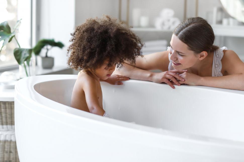 Free Image of Two persons relaxing in a modern bathtub 