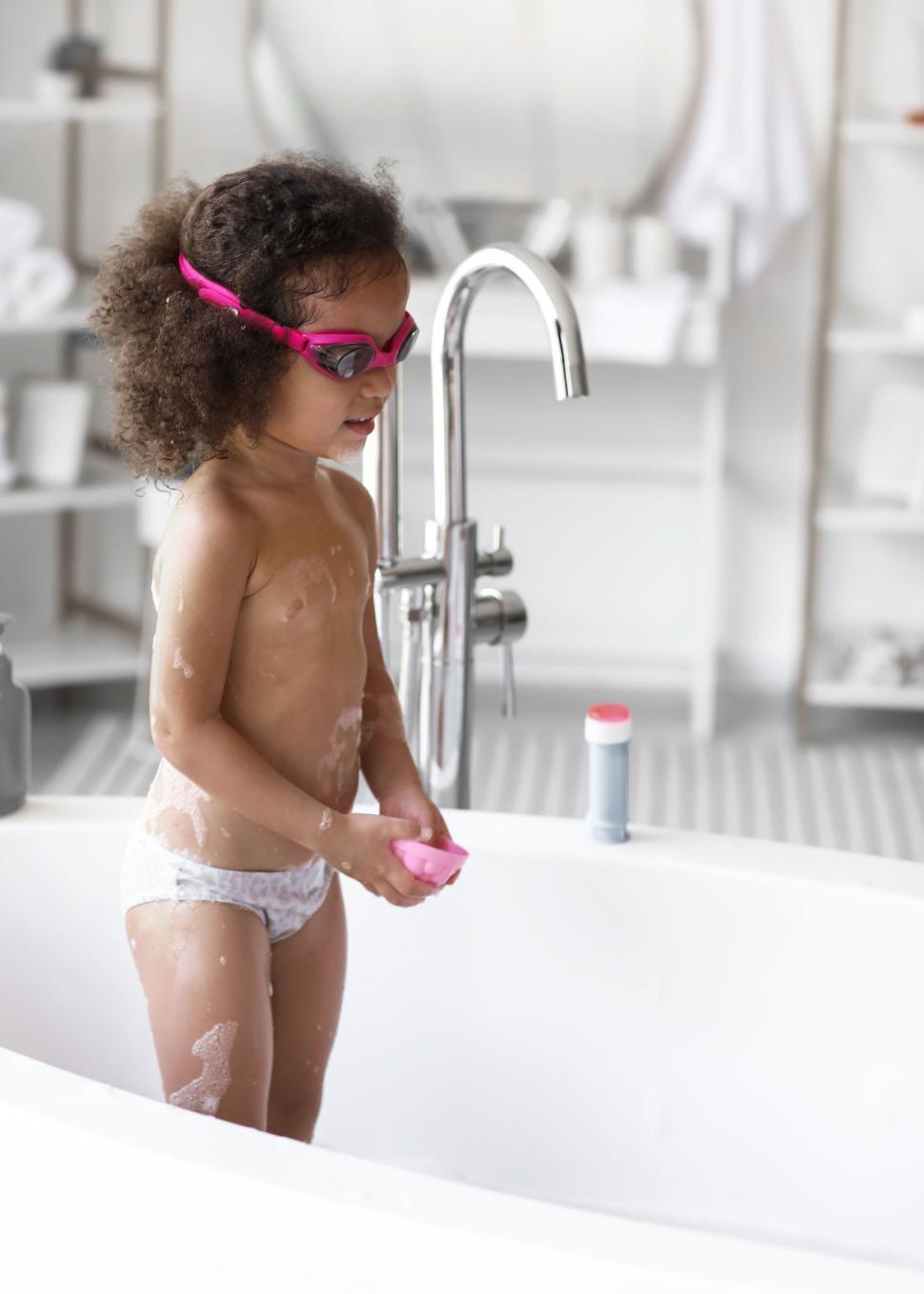 Free Image of Child playing in a bubble bath in the tub 