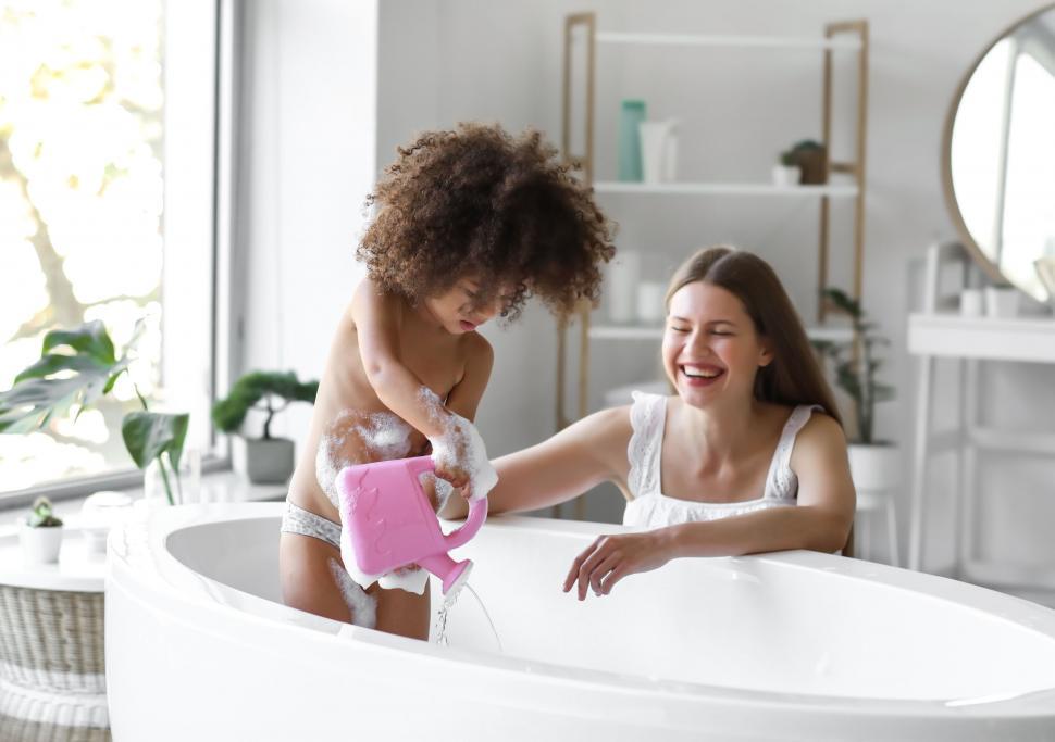 Free Image of Mother and child laughing during bath time 