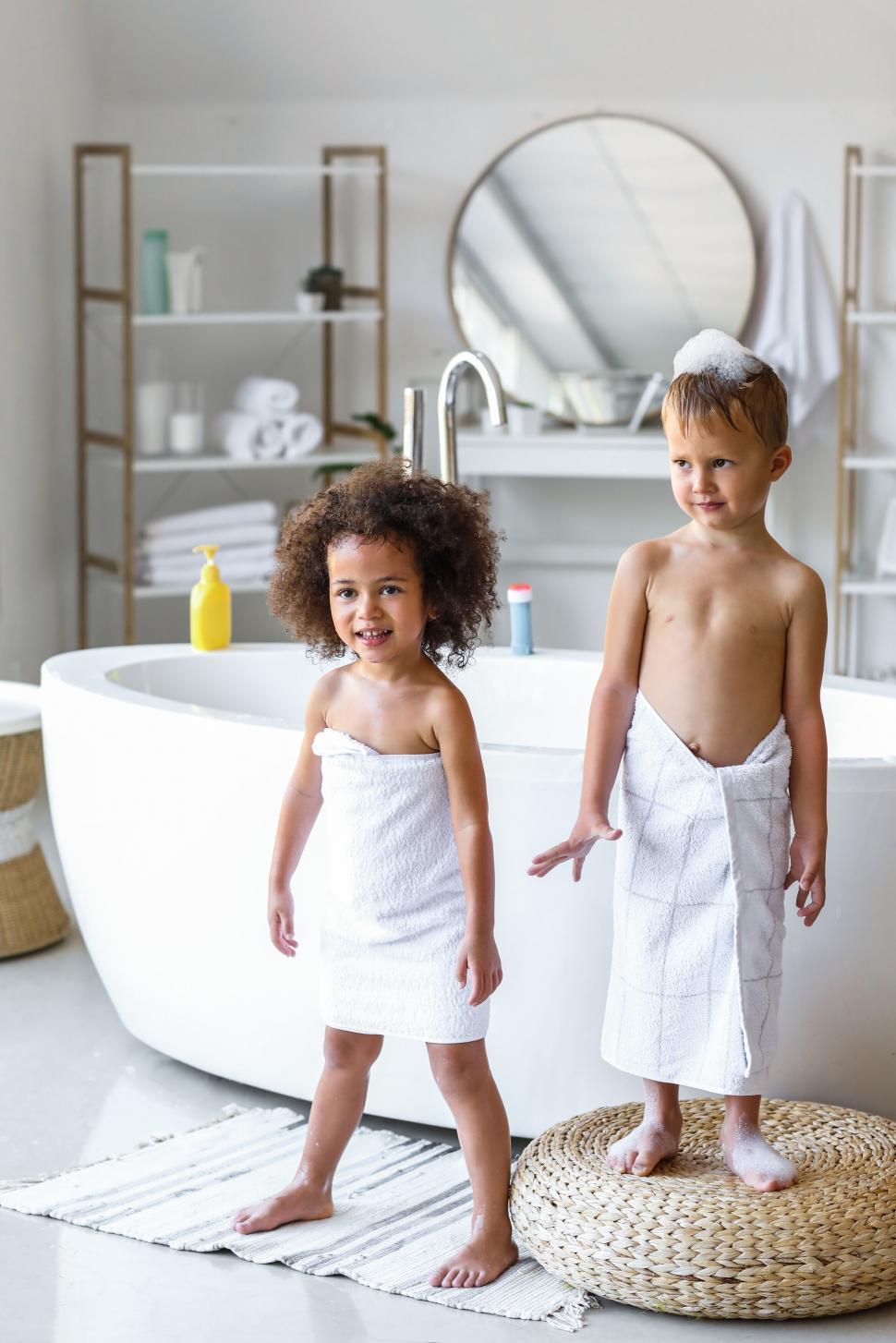 Free Image of Children in towels standing in bathroom 