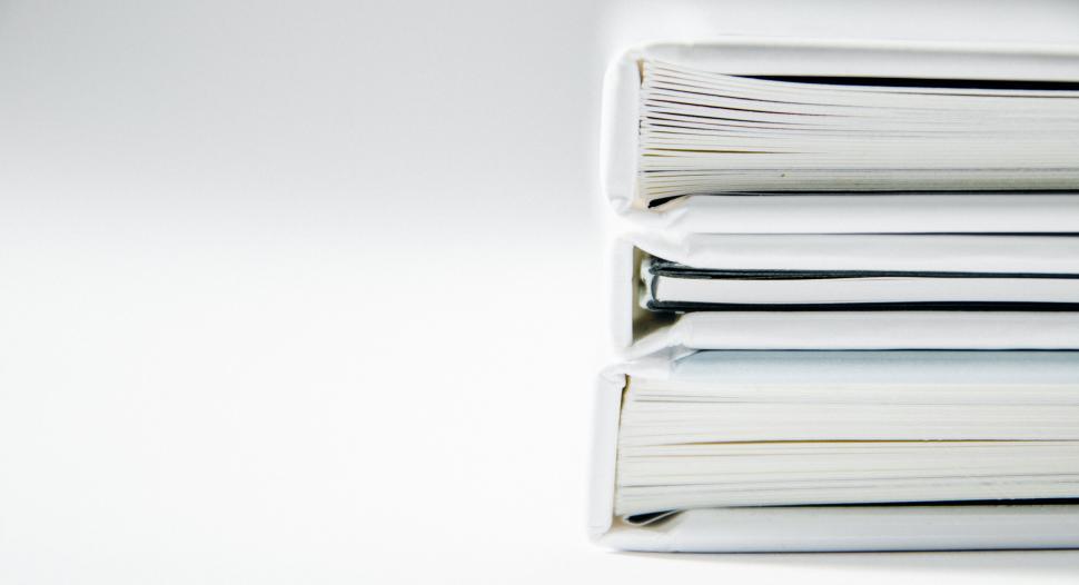 Free Image of Stack of four white books on plain background 
