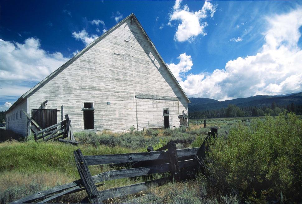 Free Image of barn mountains fences abandoned fields ranch farm pastures bleached dilapidated disrepair decaying rural building wooden corrals california 
