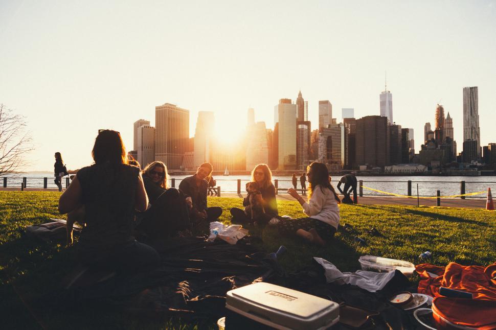 Free Image of Friends enjoying sunset picnic in the city 