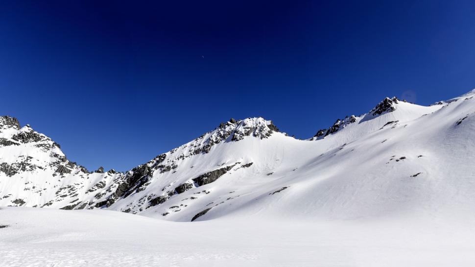Free Image of Majestic snowy mountain under blue sky 