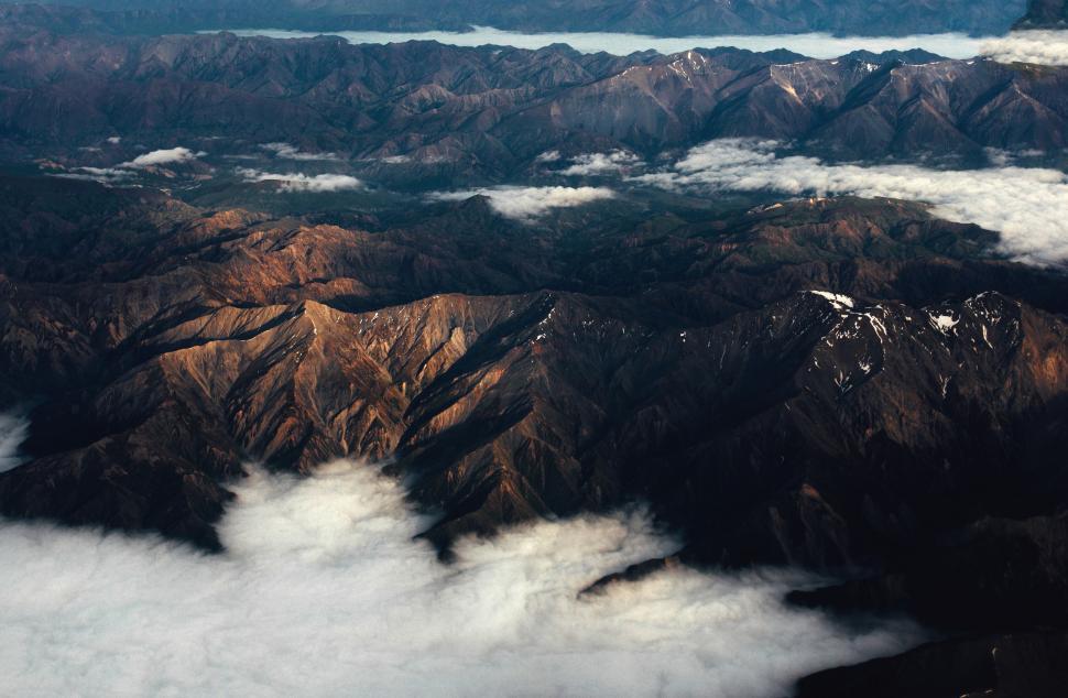 Free Image of Aerial view of sunlit mountain peaks 