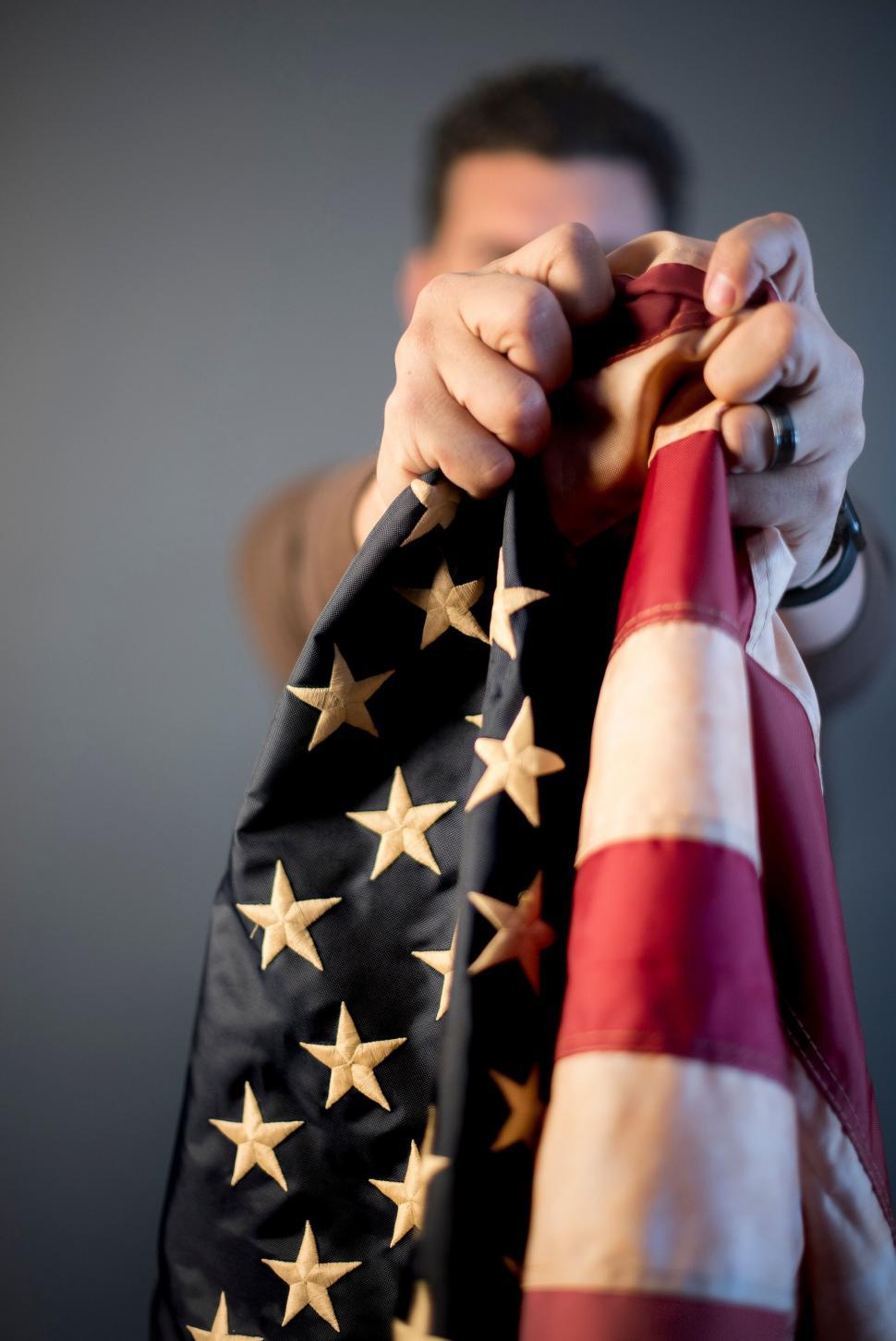 Free Image of Patriotic person holding an American flag 