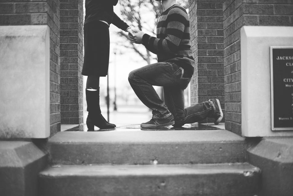 Free Image of Couple engagement moment caught on stairs 