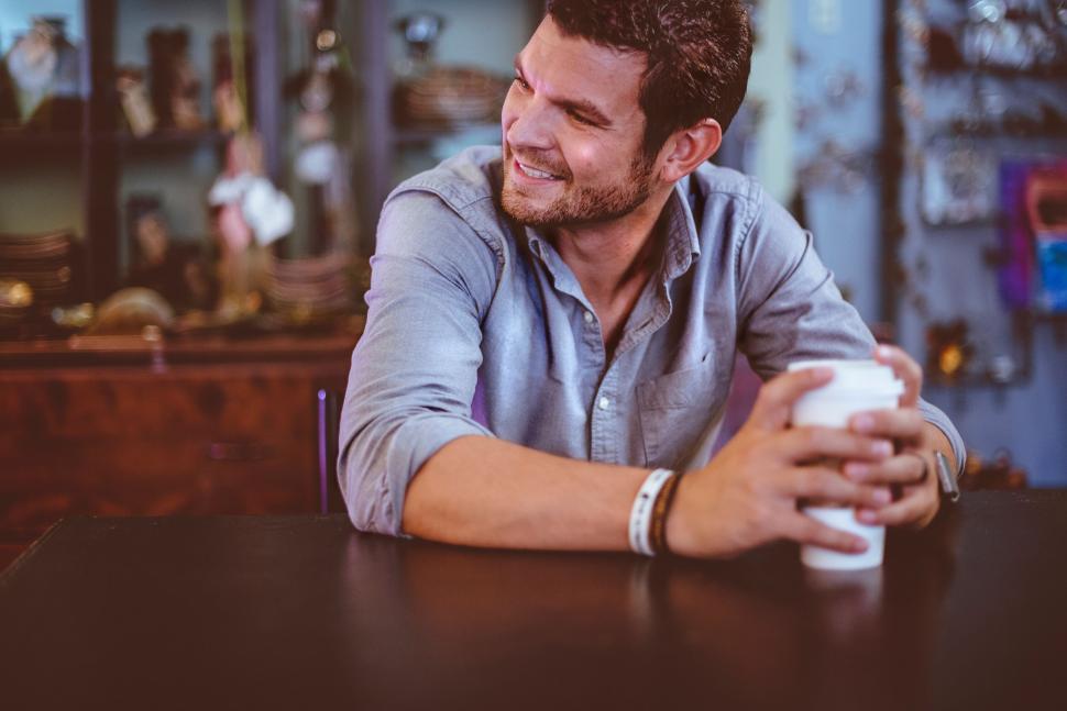 Free Image of Man drinking coffee in vintage cafe environment 