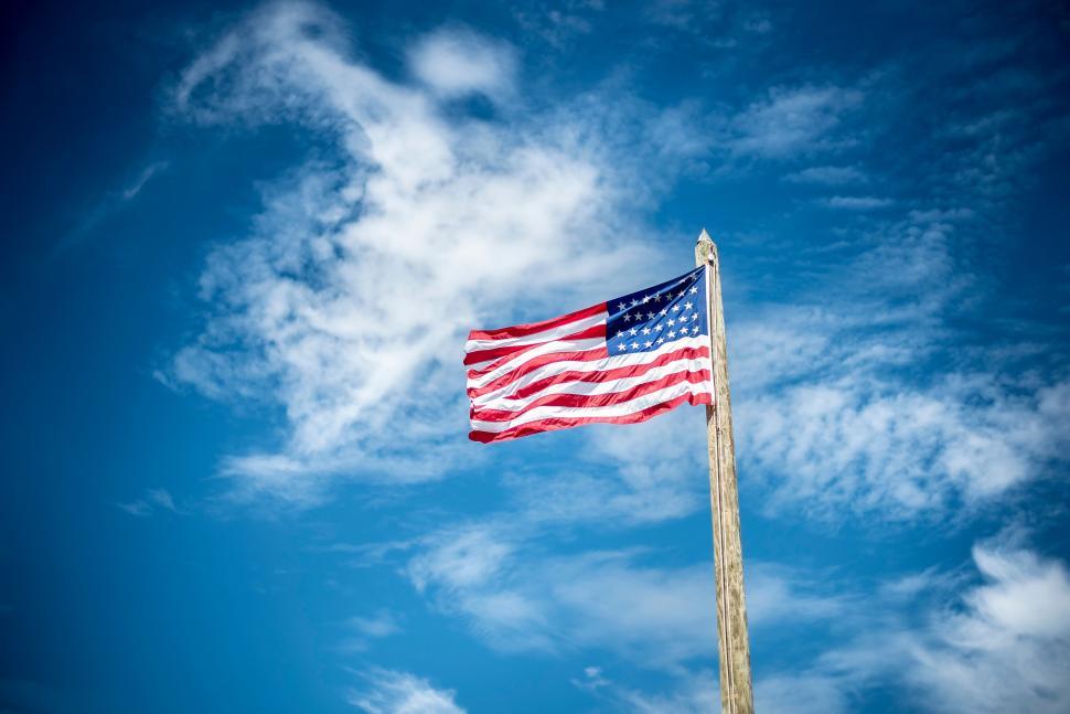 Free Image of American flag waving against blue sky 
