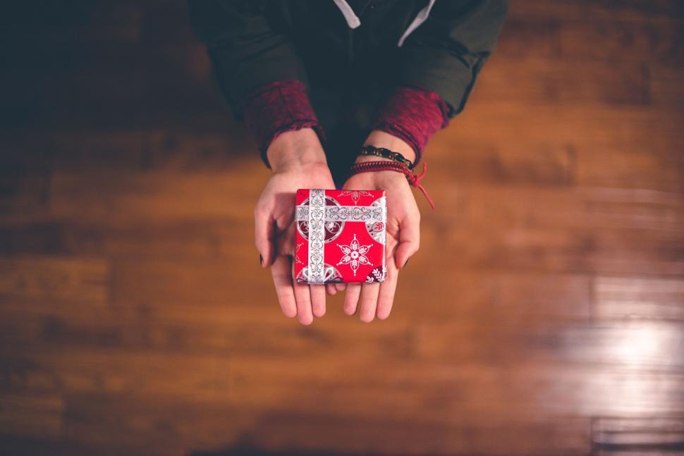 Free Image of Hands holding a small red gift box 