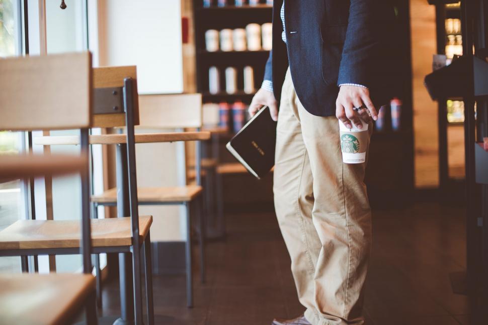 Free Image of Man with coffee and book in cafe 