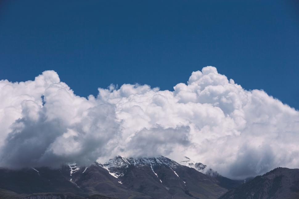 Free Image of Cloudy mountain landscape in clear blue sky 