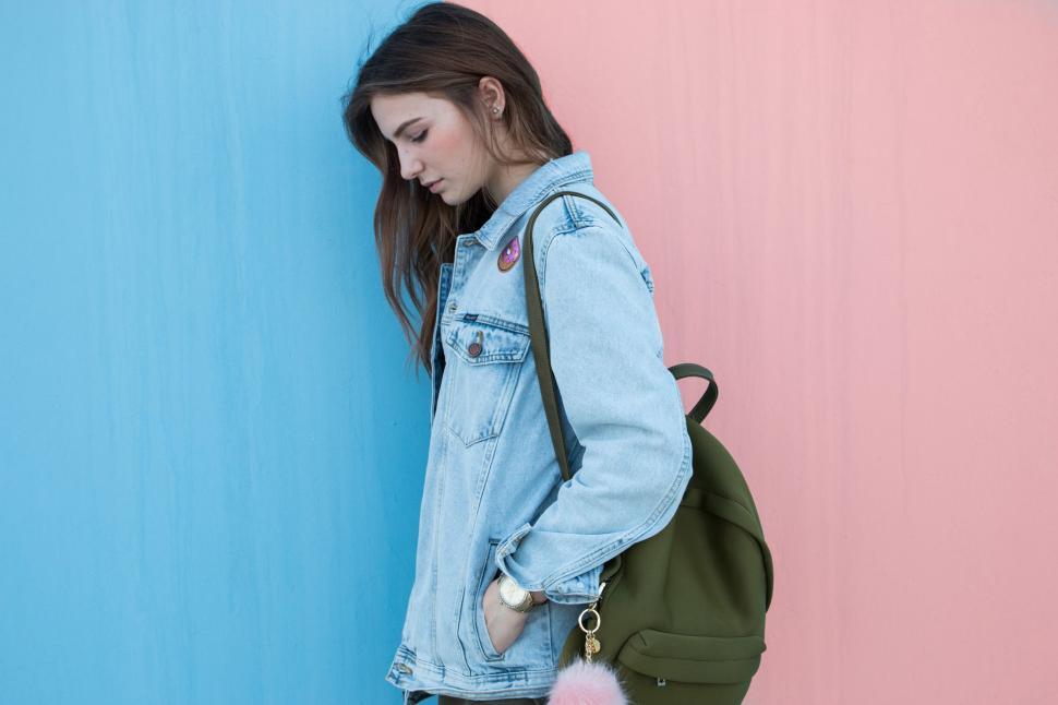 Free Image of Young woman against pastel colored walls 