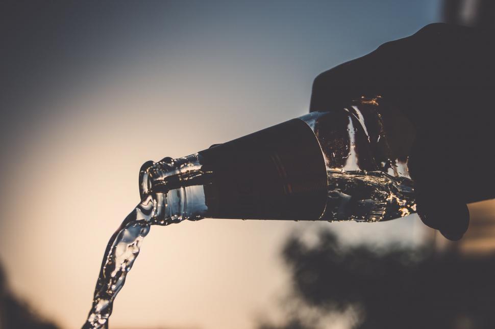 Free Image of Silhouette of pouring water from bottle 