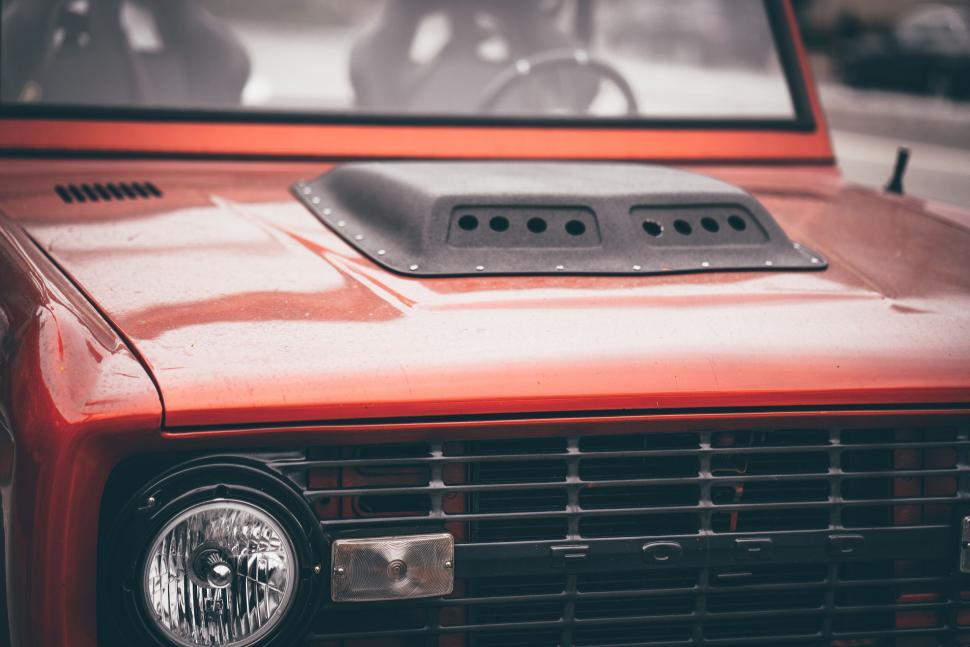 Free Image of Vintage red car hood and headlight detail 
