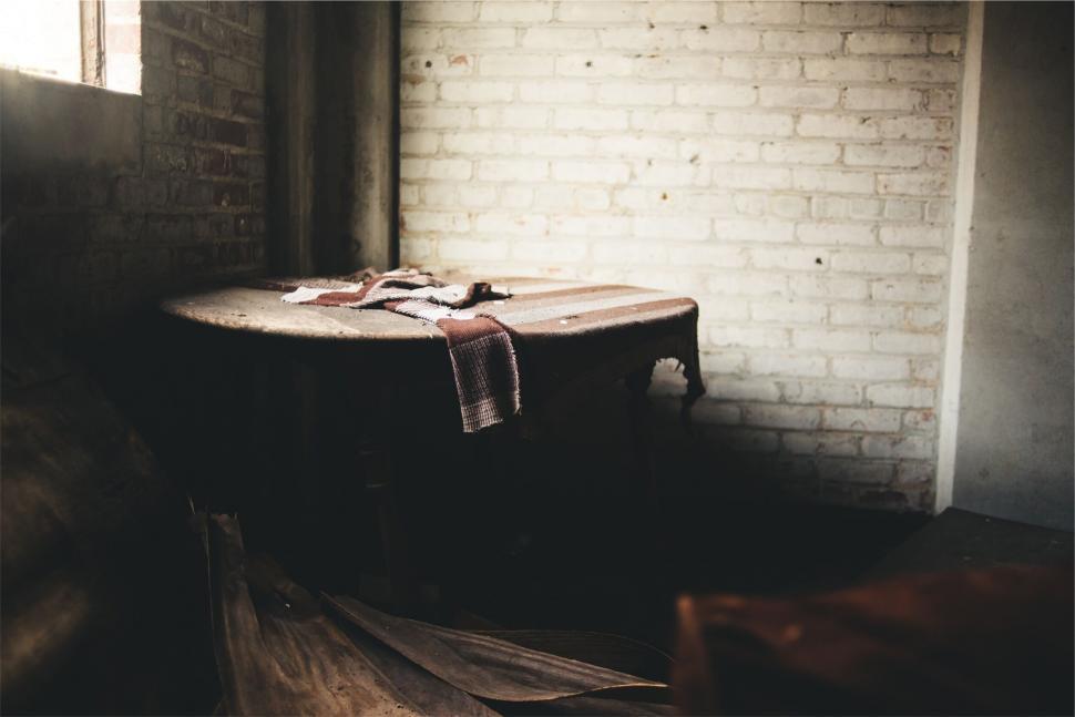 Free Image of Abandoned table in a derelict building setting 