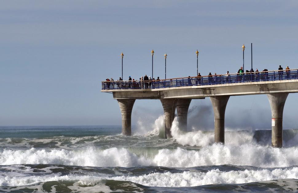 Free Image of Stormy sea at concrete pier with onlookers 