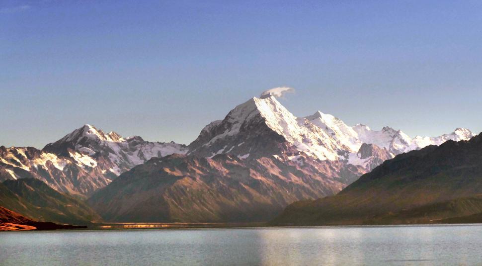Free Image of Majestic mountain peak reflecting in tranquil lake 