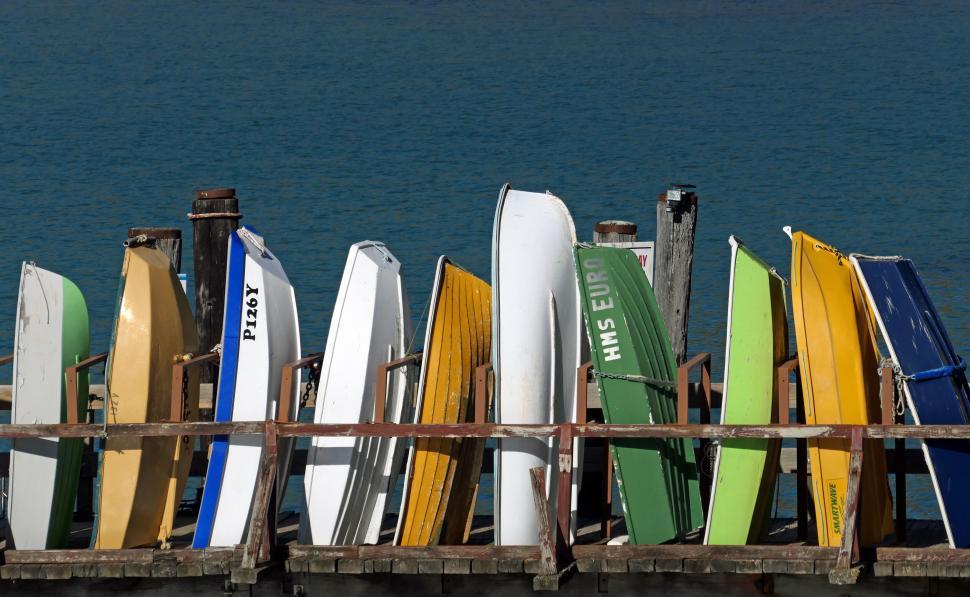 Free Image of Boats stacked on a wooden dock by the sea 