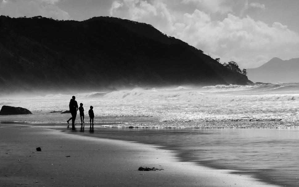 Free Image of Black and white beach silhouette with family 