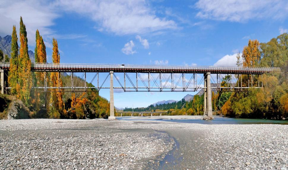 Free Image of Old train bridge over autumn river scene 
