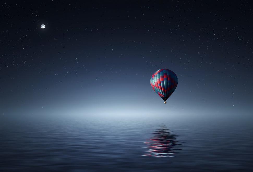Free Image of Hot Air Balloon over Calm Night Waters 