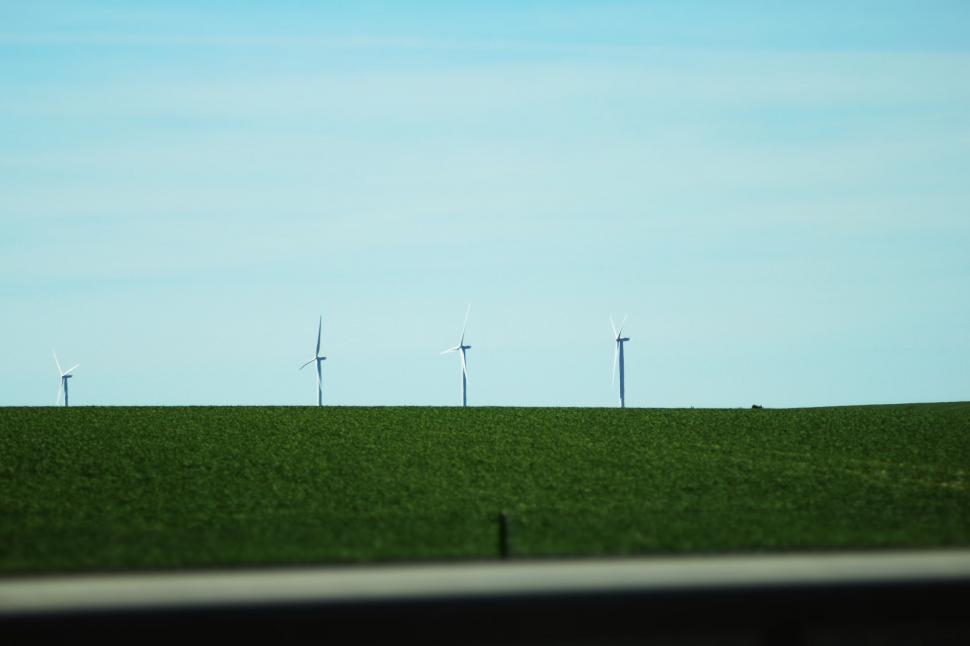 Free Image of Wind turbines on a green hillside 