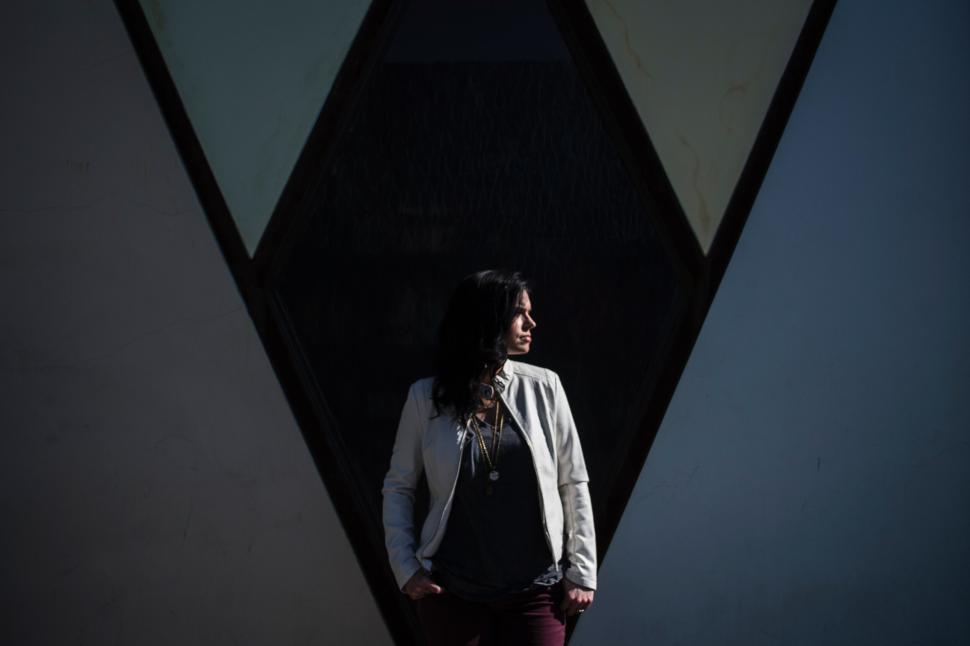 Free Image of Woman in front of a geometric structure 