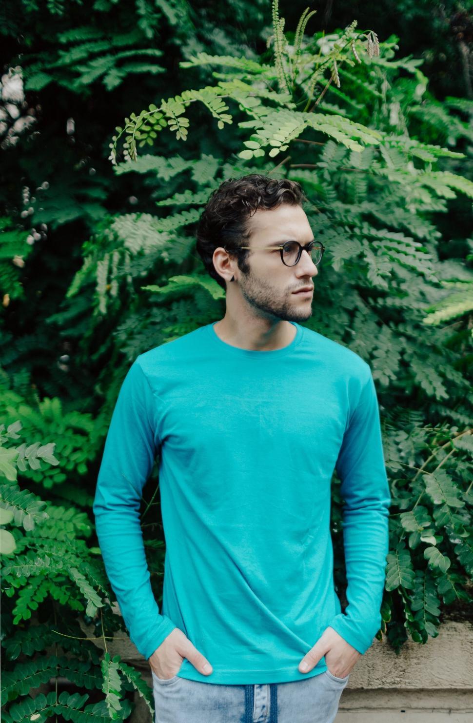 Free Image of Man in blue shirt against greenery 