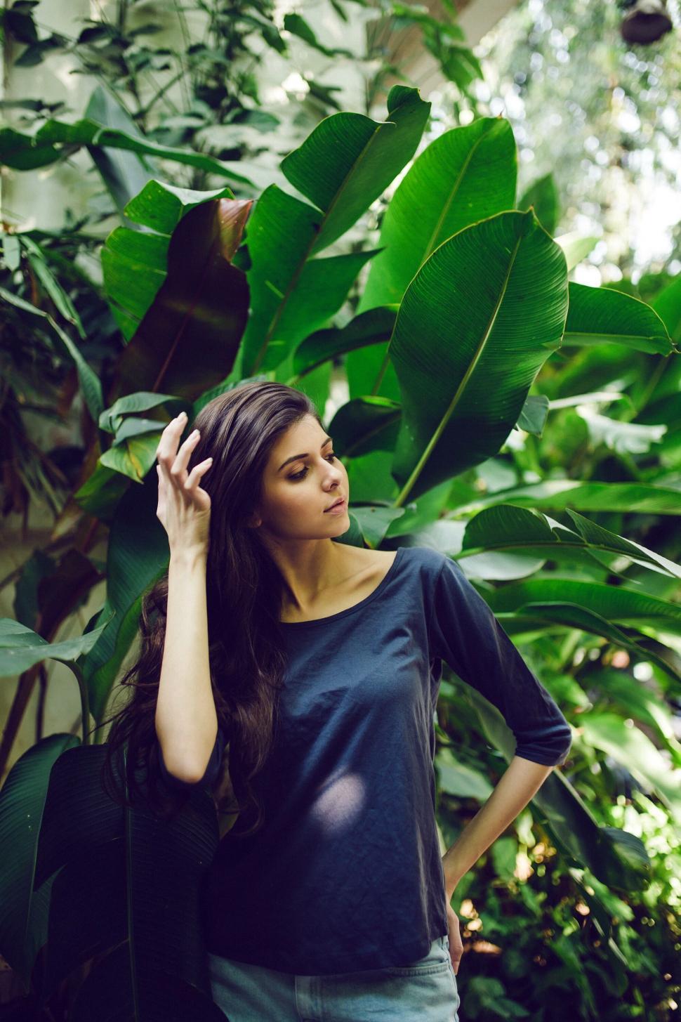 Free Image of Woman with hand in hair among leaves 
