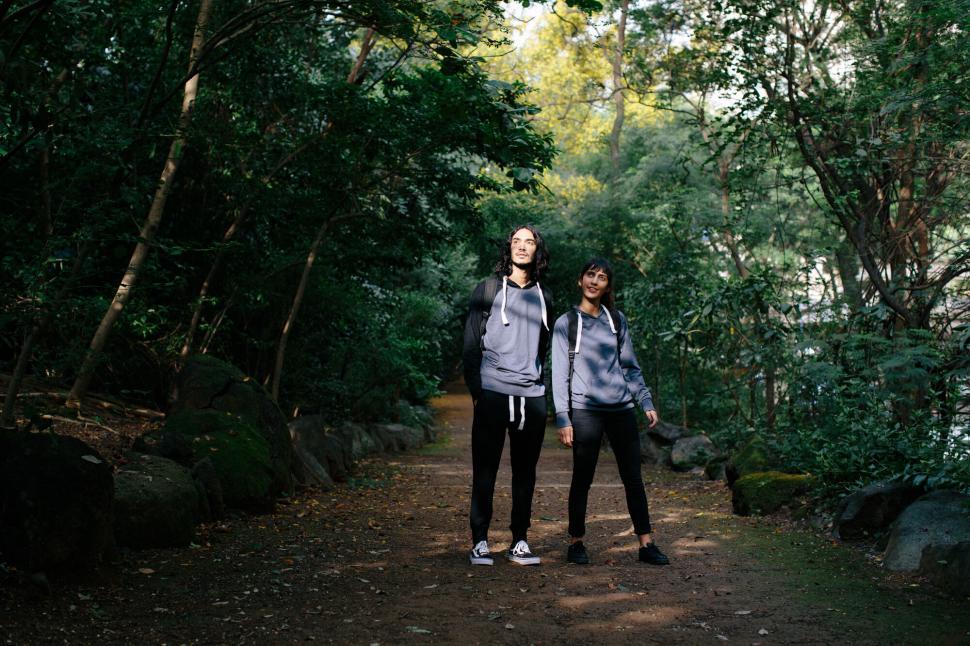 Free Image of Couple trekking in forest landscape 