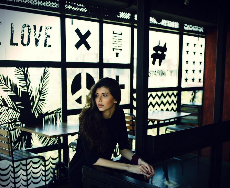Free Image of Woman in moody cafe interior 