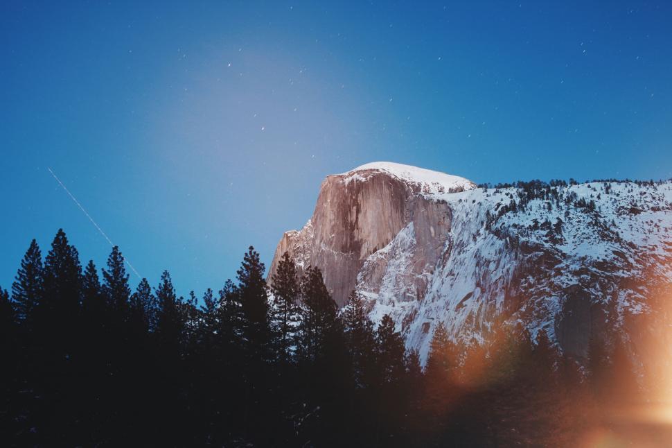 Free Image of Snow-capped Half Dome under starry sky 