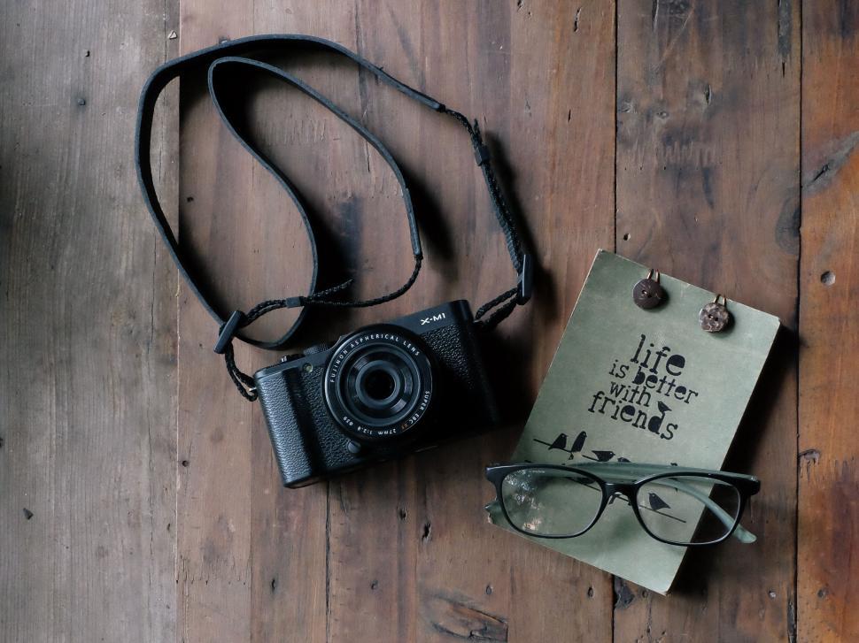 Free Image of Retro camera with journal and glasses on wood 