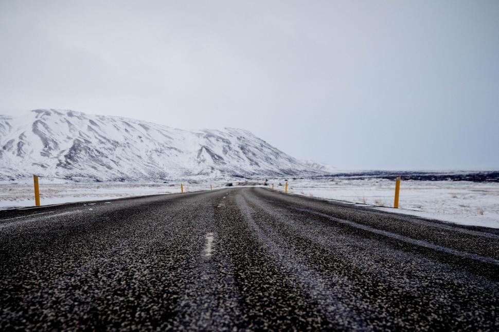 Free Image of Icy road leading towards snowy mountains 