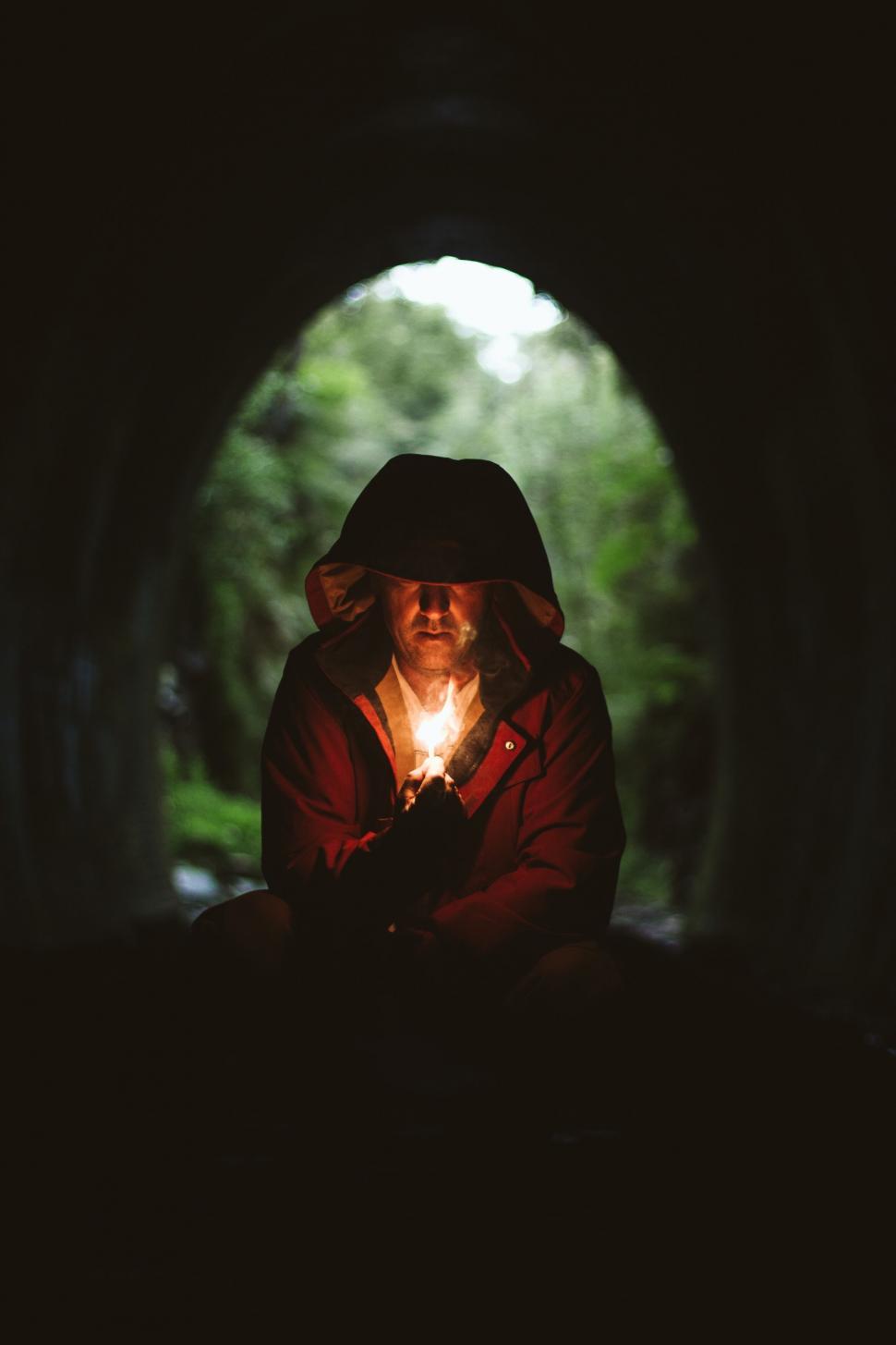 Free Image of Person with illuminated lantern in tunnel 