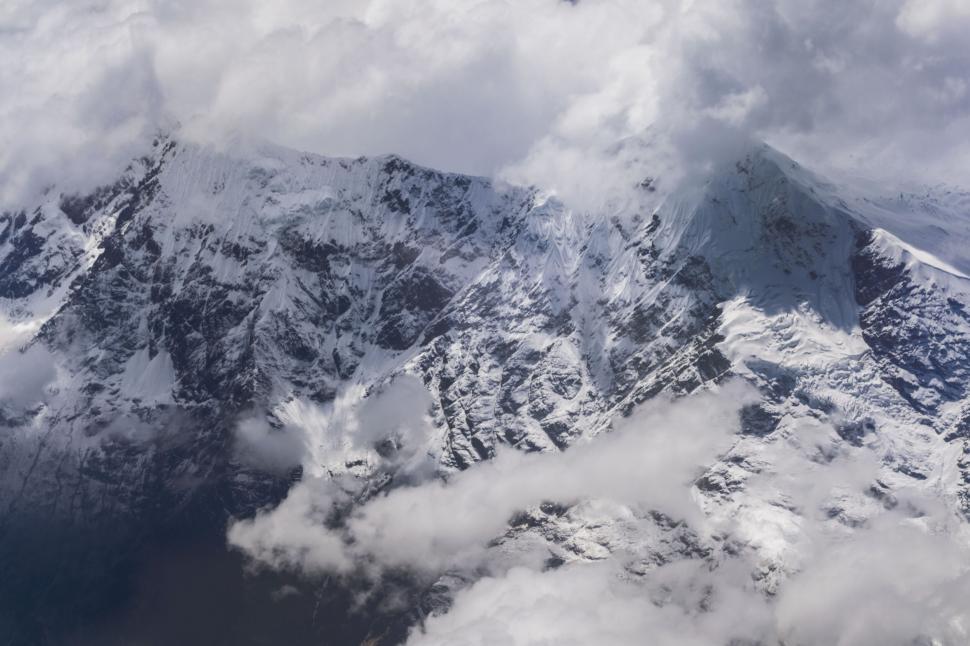 Free Image of Aerial shot of cloudy mountain peaks 