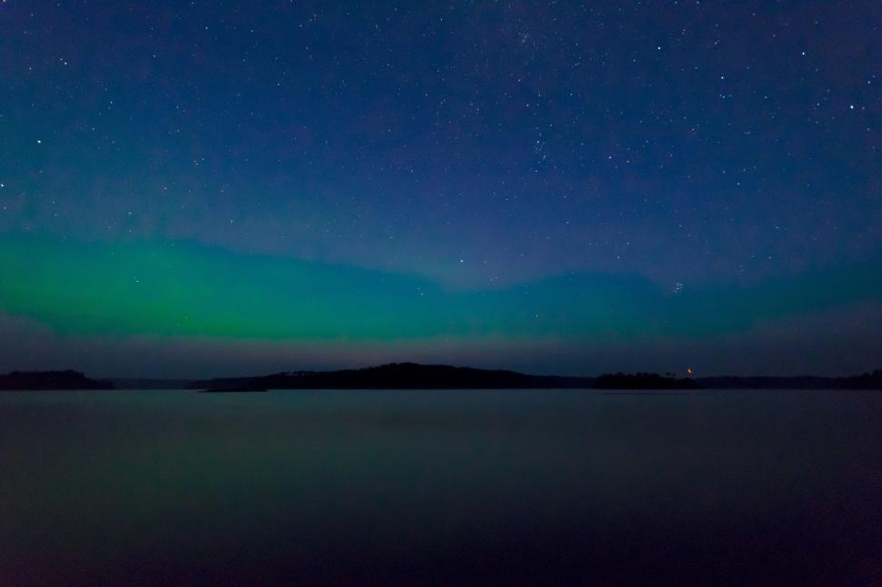 Free Image of Aurora borealis over tranquil lake at night 