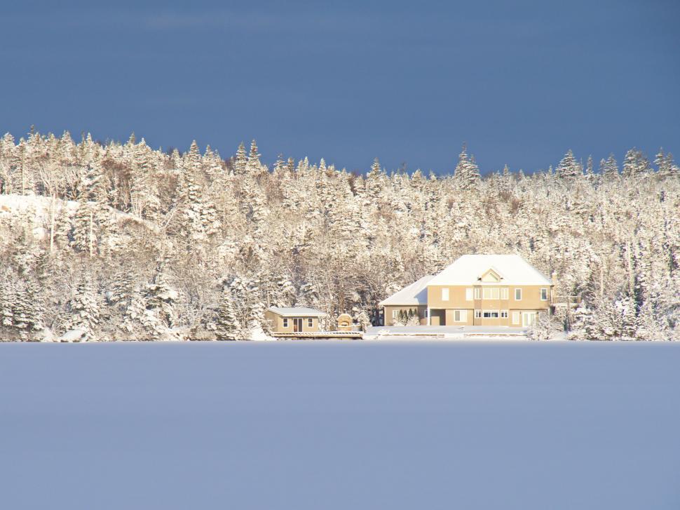 Free Image of Winter landscape with house and snow-covered trees 