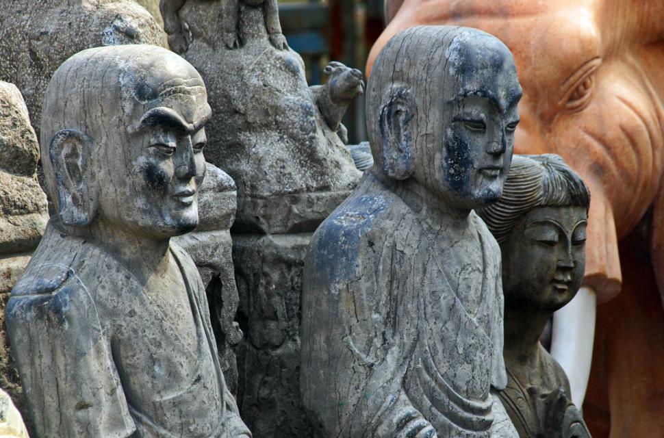 Free Image of Ancient stone carvings with blurred faces 