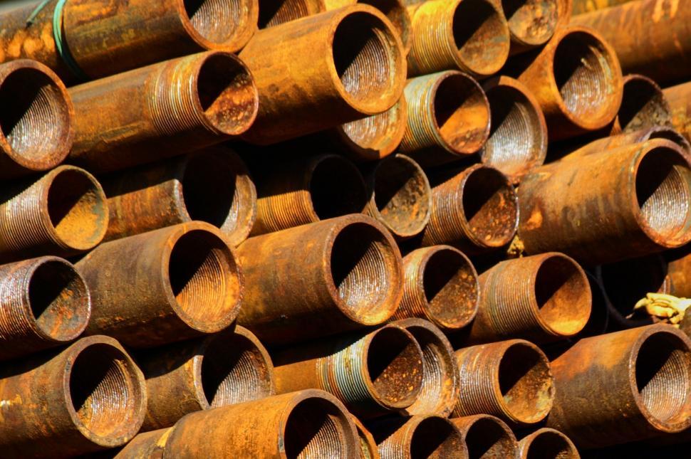Free Image of Rusty metal pipes stacked together 