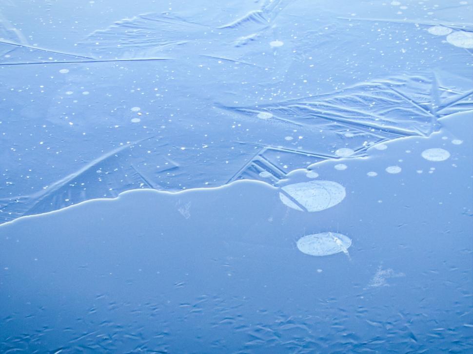 Free Image of Frozen lake with patterned ice and bubbles 